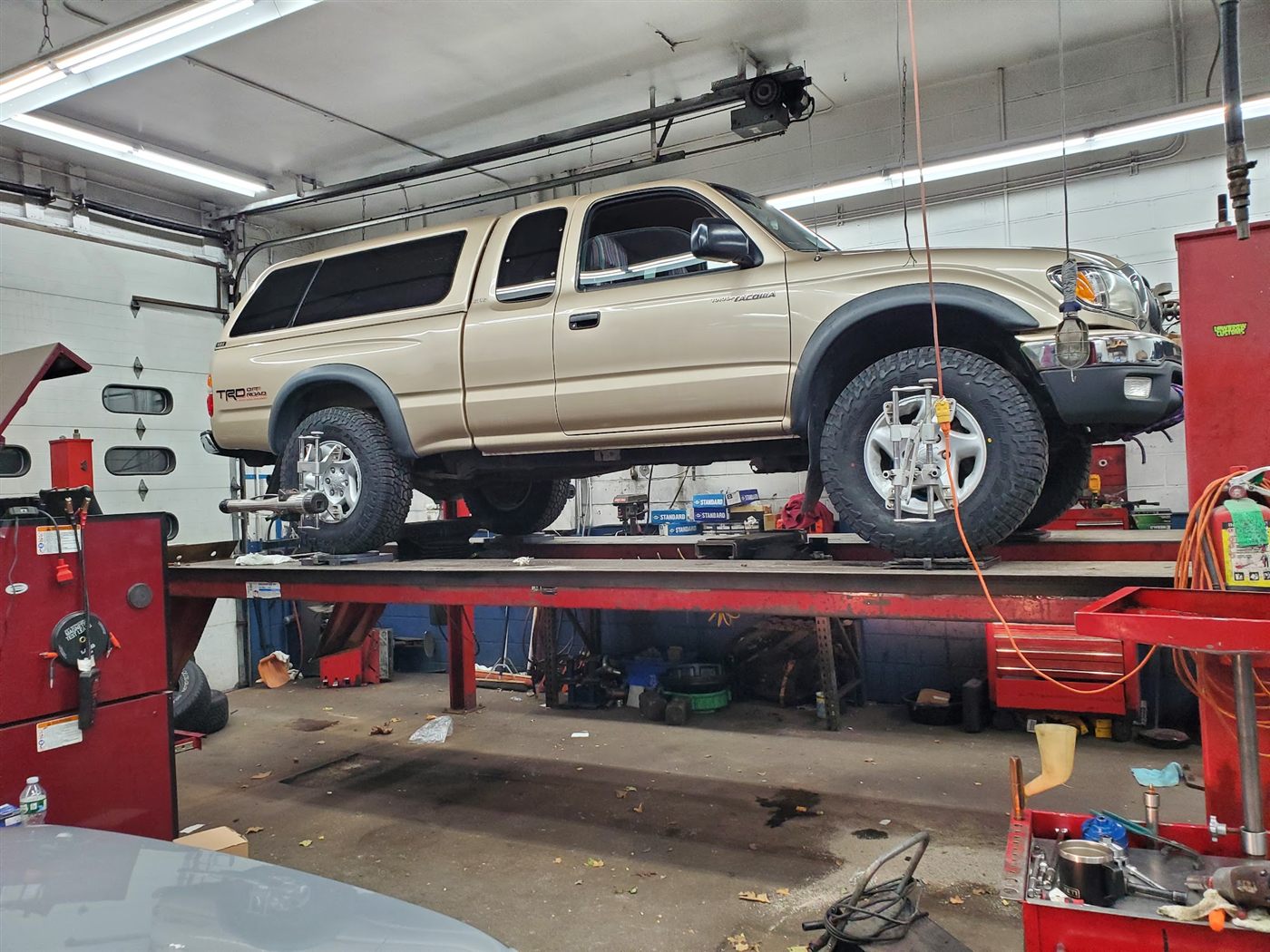 A Toyota Tacoma up on the alignment rack inside Dave's shop